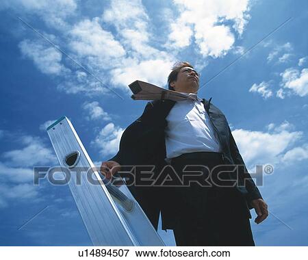 Image of a Businessman Standing on a Metallic Ladder Under a Blue Sky, Low Angle View View Large Photo Image Stock Photo - Image of a Businessman Standing on a Metallic Ladder Under a Blue Sky, Low Angle View. Fotosearch