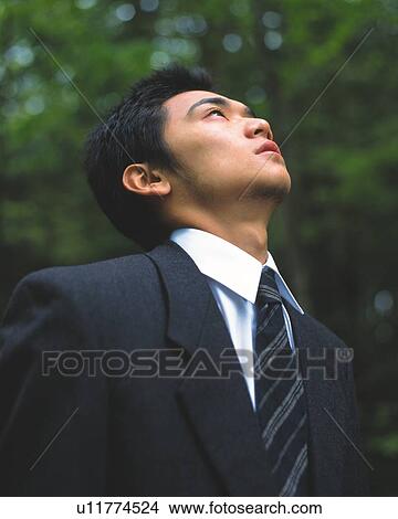 Image of a Businessman Surrounded By Green, Looking Up, Low Angle View, Side View, Differential Focus View Large Photo Image Picture - Image of a Businessman Surrounded By Green, Looking Up, Low Angle View, Side View, Differential Focus. Fotosearch