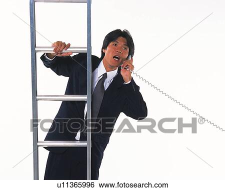 Stock Photograph - Image of a Businessman Talking on a Phone While Climbing on a Metallic Ladder, Front View. Fotosearch