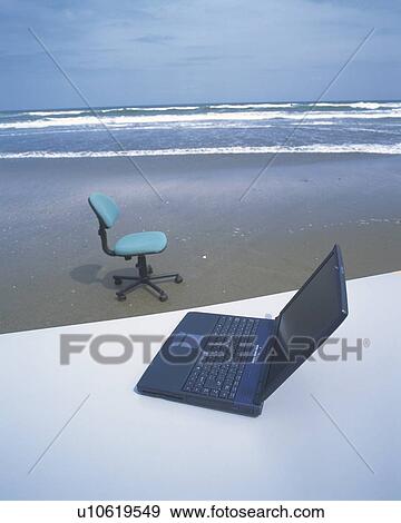 Stock Photo - Image of a Laptop and an Office Chair at the Beach, High Angle View. Fotosearch