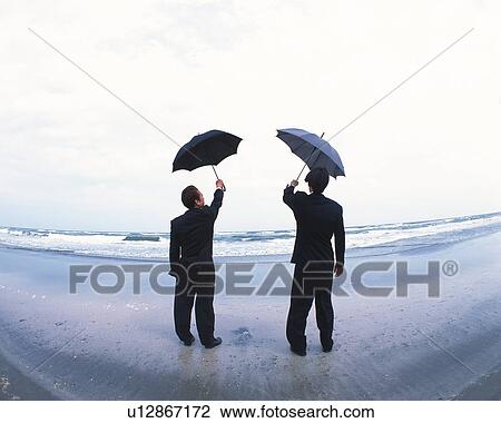 Image of Two Businessmen Holding an Umbrella In the Air, Looking at the Sea, Rear View, Fish Eye View Large Photo Image Stock Image - Image of Two Businessmen Holding an Umbrella In the Air, Looking at the Sea, Rear View, Fish Eye. Fotosearch