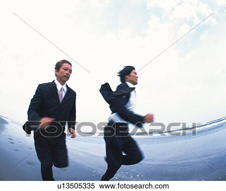 Image of Two Businessmen Running Along the Beach, Low Angle View, Blurred Motion, Side View, Fish Eye View Large Photo Image Stock Photography - Image of Two Businessmen Running Along the Beach, Low Angle View, Blurred Motion, Side View, Fish Eye. Fotosearch
