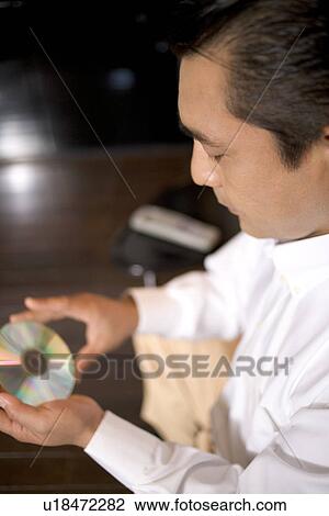 Mature Adult Man Holding a CD View Large Photo Image Stock Image - Mature Adult Man Holding a CD. Fotosearch