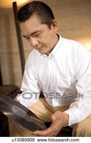 Mature Adult Man Holding a LP View Large Photo Image Stock Photo - Mature Adult Man Holding a LP. Fotosearch