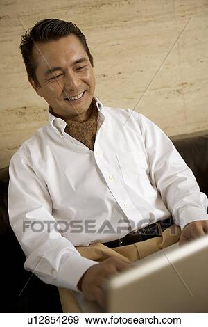 Mature Adult Man Using a Computer View Large Photo Image Stock Photo - Mature Adult Man Using a Computer. Fotosearch