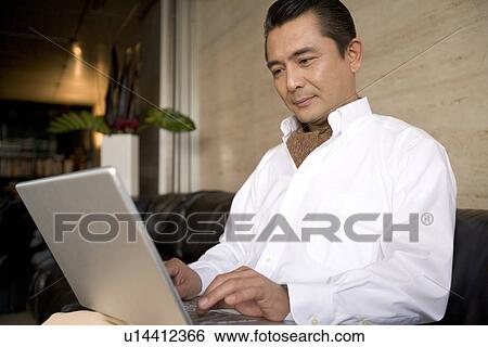 Stock Photograph - Mature Adult Man Using a Computer. Fotosearch