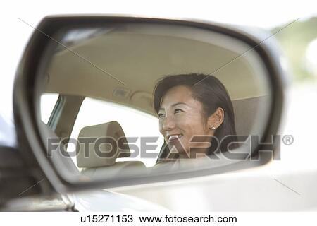 Stock Image - Mature Adult Woman Driving a Car. Fotosearch