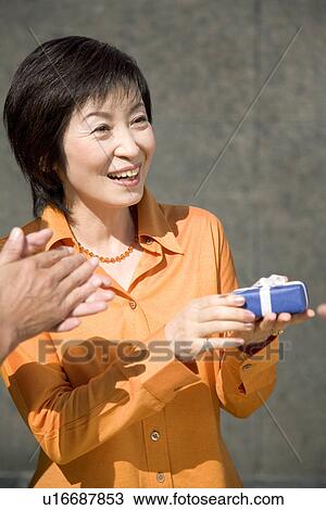 Mature Adult Woman Received a Present View Large Photo Image Stock Image - Mature Adult Woman Received a Present. Fotosearch