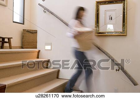 Mid Adult Woman Carrying a Laundry View Large Photo Image Stock Image - Mid Adult Woman Carrying a Laundry. Fotosearch