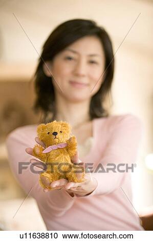 Mid Adult Woman Holding a Teddy Bear View Large Photo Image Stock Image - Mid Adult Woman Holding a Teddy Bear. Fotosearch