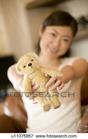 Stock Photo - Mid Adult Woman Holding a Teddy Bear. Fotosearch