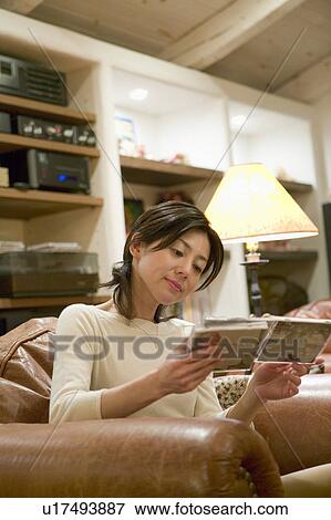 Stock Photo - Mid Adult Woman Listening to Music. Fotosearch
