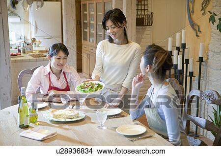 Picture - Three Mid Adult Women Eating a Meal. Fotosearch