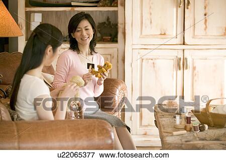 Stock Photo - Two Mid Adult Women Holding a Teddy Bear. Fotosearch