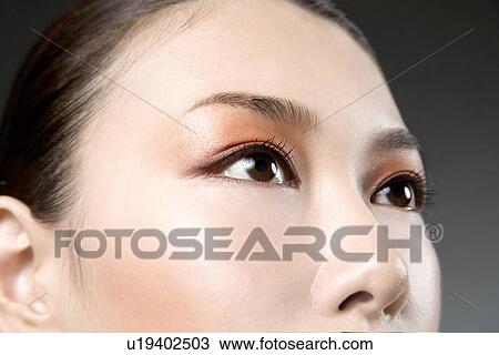 Stock Image - Mid Adult Woman Looking up. Fotosearch