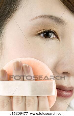 Young Woman Applying Face Powder with Puff View Large Photo Image Stock Photo - Young Woman Applying Face Powder with Puff. Fotosearch