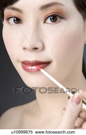 Young Woman Applying Lipstick with Lip Brush View Large Photo Image Stock Photography - Young Woman Applying Lipstick with Lip Brush. Fotosearch