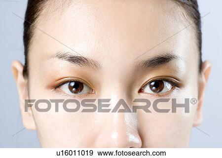 Young Woman Looking at Camera, Close Up View Large Photo Image Stock Photo - Young Woman Looking at Camera, Close Up. Fotosearch