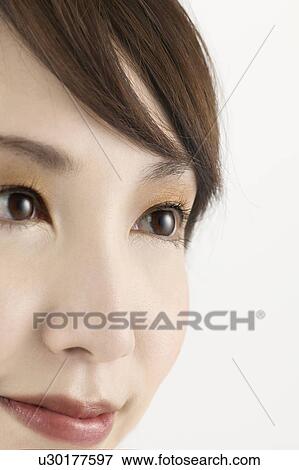 Stock Photo - Young Woman Looking Away, Close Up. Fotosearch