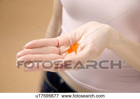 Young Woman Showing Moisturizer in Hand View Large Photo Image Stock Photo - Young Woman Showing Moisturizer in Hand. Fotosearch