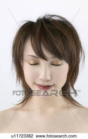 Stock Image - Young Woman Smiling, Eyes Closed. Fotosearch