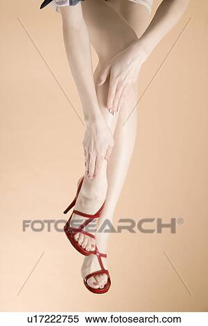 Young Woman Touching Leg, Low Section View Large Photo Image Stock Photography - Young Woman Touching Leg, Low Section. Fotosearch