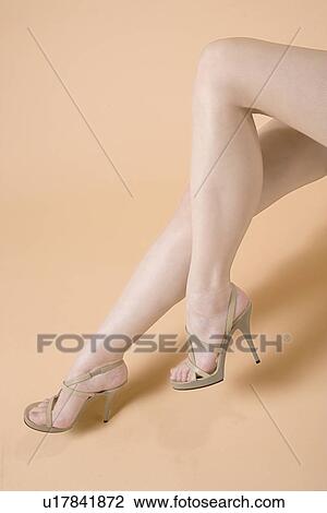 Stock Image - Young Woman's Legs, Sitting. Fotosearch