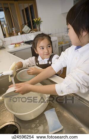 Brother and Sister are washing dishes View Large Photo Image Picture - Brother and Sister are washing dishes. Fotosearch