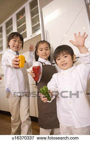 Children are holding the bell pepper (red, green, yellow) View Large Photo Image Stock Photo - Children are holding the bell pepper (red, green, yellow). Fotosearch