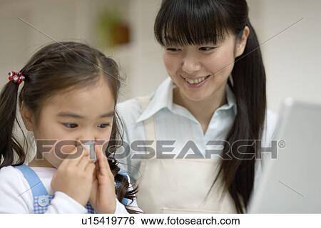 Stock Photograph - Girl blowing her nose. Fotosearch