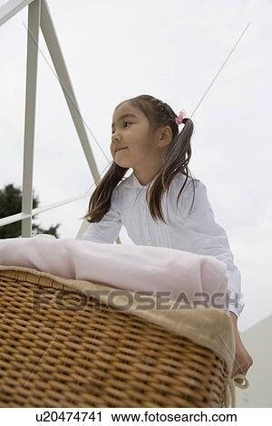 Stock Image - Girl carrying a laundry. Fotosearch