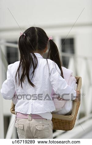 Stock Photo - Girl carrying a laundry. Fotosearch
