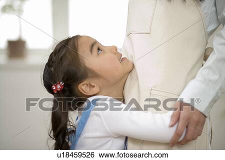 Stock Photograph - Girl hugging her mother. Fotosearch