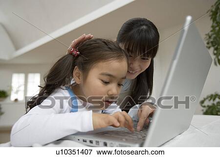 Stock Photo - Girl learning to use a computer. Fotosearch