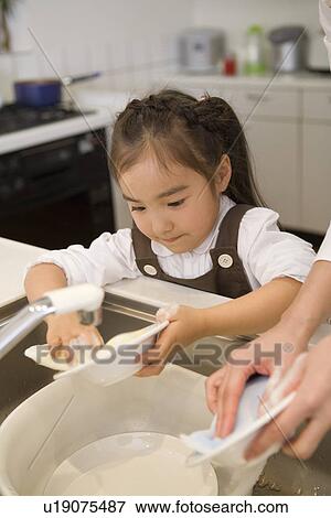 Stock Photo - Girl washing dishes. Fotosearch