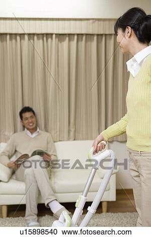 Stock Image - Husband and Wife are talking at living room. Fotosearch
