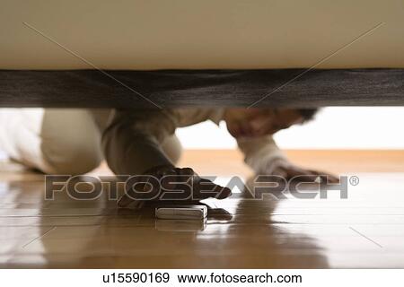 Mid Adult Man crouching down View Large Photo Image Stock Photo - Mid Adult Man crouching down . Fotosearch
