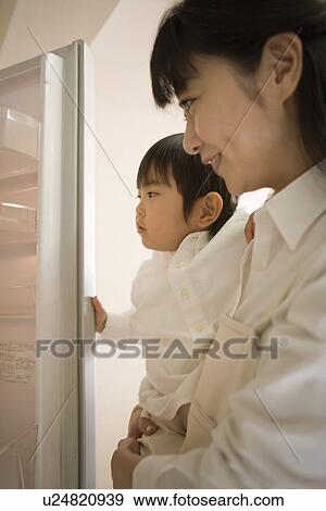 Stock Photo - Mid Adult Woman holding a son. Fotosearch