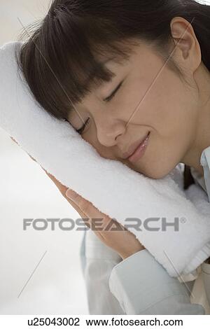 Mid Adult Woman put her face on the clean towel View Large Photo Image Stock Image - Mid Adult Woman put her face on the clean towel. Fotosearch