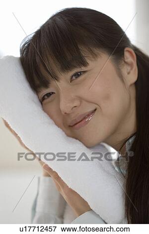 Mid Adult Woman put her face on the clean towel View Large Photo Image Stock Photo - Mid Adult Woman put her face on the clean towel. Fotosearch