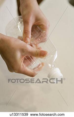 Mid Adult Woman smashing a PET bottle for a recycle View Large Photo Image Stock Photo - Mid Adult Woman smashing a PET bottle for a recycle. Fotosearch