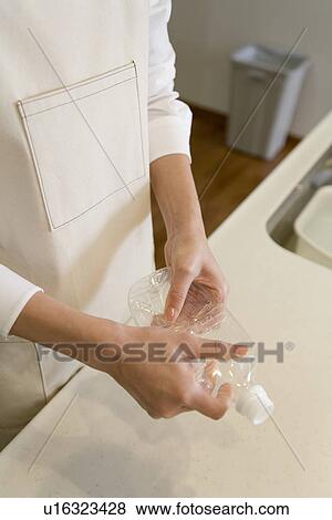 Mid Adult Woman smashing a PET bottle for a recycle View Large Photo Image Stock Photo - Mid Adult Woman smashing a PET bottle for a recycle. Fotosearch