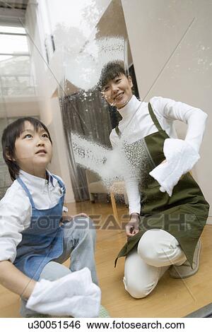 Mother and Son cleaning a window View Large Photo Image Stock Photograph - Mother and Son cleaning a window. Fotosearch