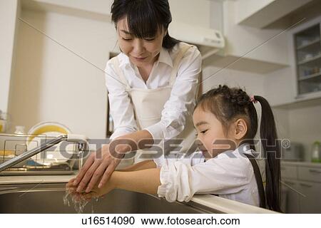 Parent and child are washing hands together View Large Photo Image Stock Image - Parent and child are washing hands together . Fotosearch