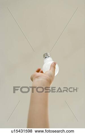 Stock Photo - Reaching to change ther light bulb. Fotosearch
