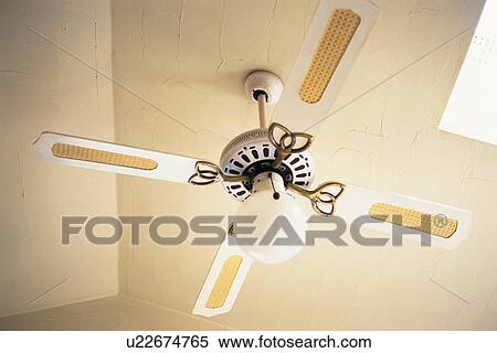 Stock Photography - A Ceiling Fan and a Lamp, Low Angle View. Fotosearch