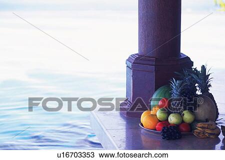 Stock Image - A Dish of Tropical Fruit by the Poolside. Fotosearch