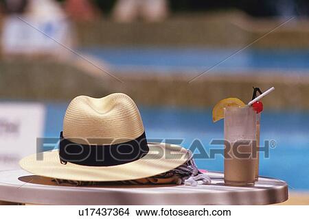 Picture - A Hat and Tropical Drink on the Table, Differential Focus. Fotosearch