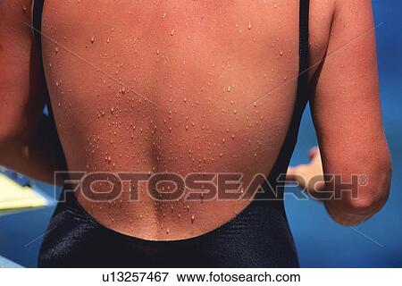 Stock Photo - Closed Up Image of a Woman Back Wearing a Swimsuit, Rear View, Differential Focus. Fotosearch