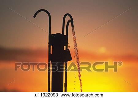 Silhouette of a Shower Against the Glow of the Sunset, Low Angle View View Large Photo Image Stock Image - Silhouette of a Shower Against the Glow of the Sunset, Low Angle View. Fotosearch